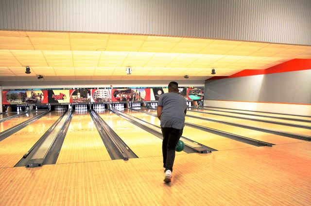 Student bowling at the Bowling and Billiards Center