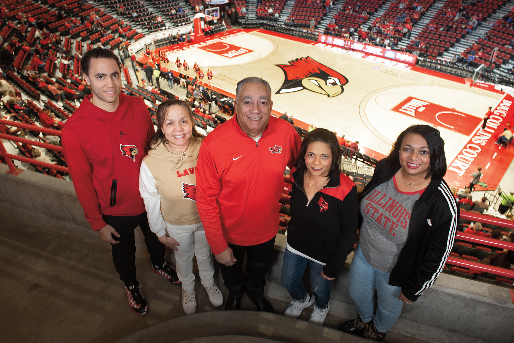 Avid Redbird basketball fans, the Jones family has attended the men’s basketball Missouri Valley Conference Tournament for 19 years. They cheer on the team at home as well, and are pictured in Redbird Arena. They are, from left, Kevin Guidry-Jones ’14, Abigail Jones, Michael Jones ’92, Tracy Jones ’03, and Ericka Jones-Carter ’02. Redbird Arena