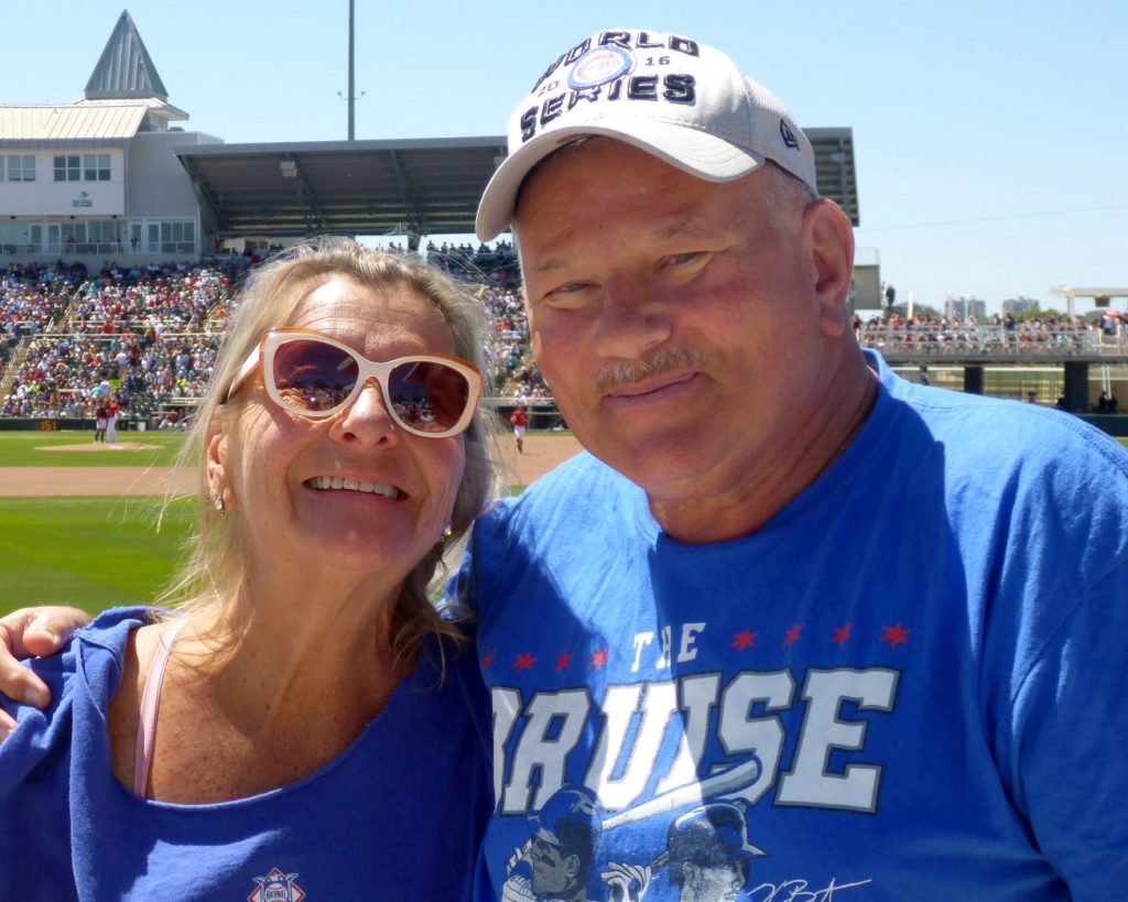 Mary Wojciechowski and Mitch Pacyna, wearing Chicago Cubs shirts, at a baseball game